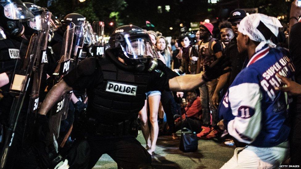 A police officer grabs a protester