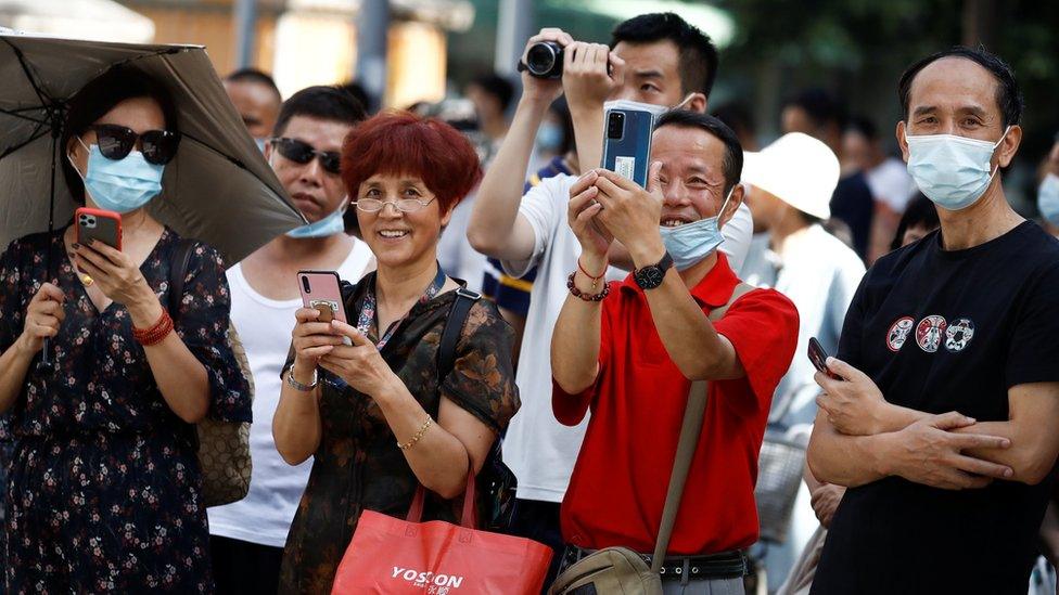 People taking pictures with their smartphones