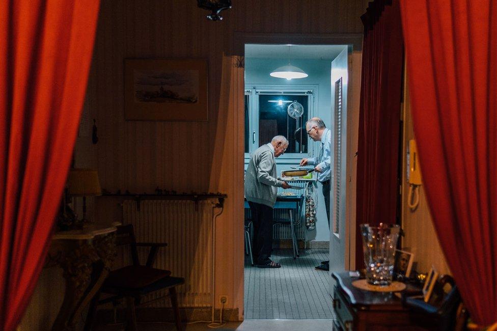 The photographer's father and grandfather cooking together for Christmas