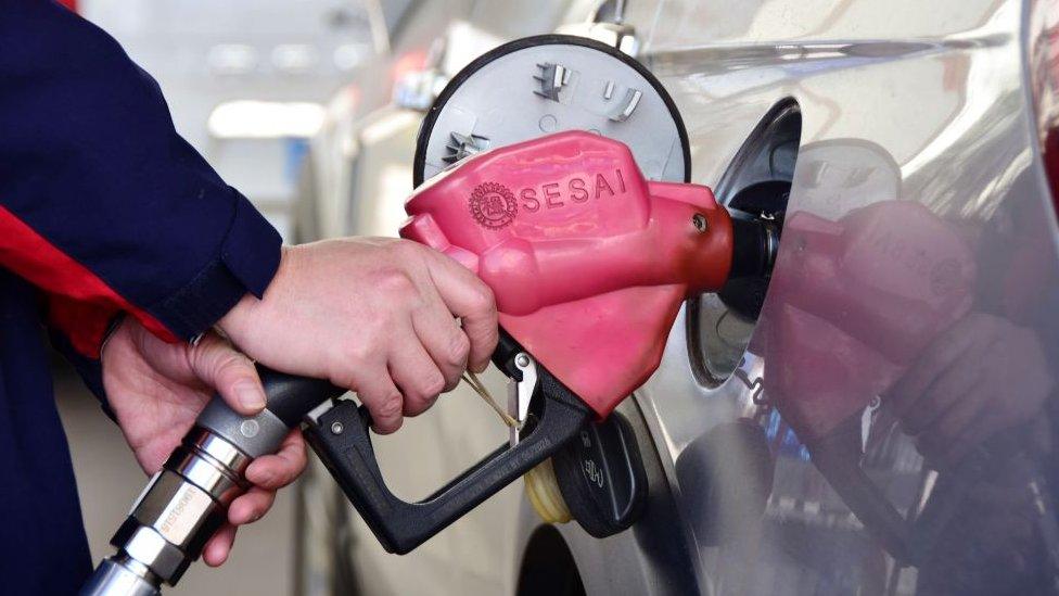 A woman filling up her car in China