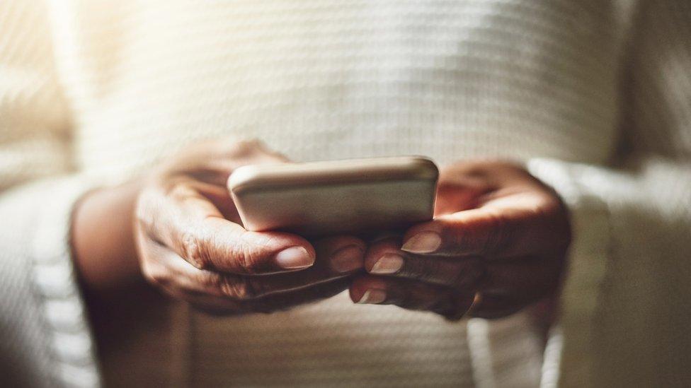 A woman holding a mobile phone