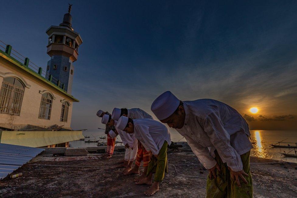 A large group of Indonesian Muslims pray at Al-Mabrur mosque in Surabaya, Indonesia