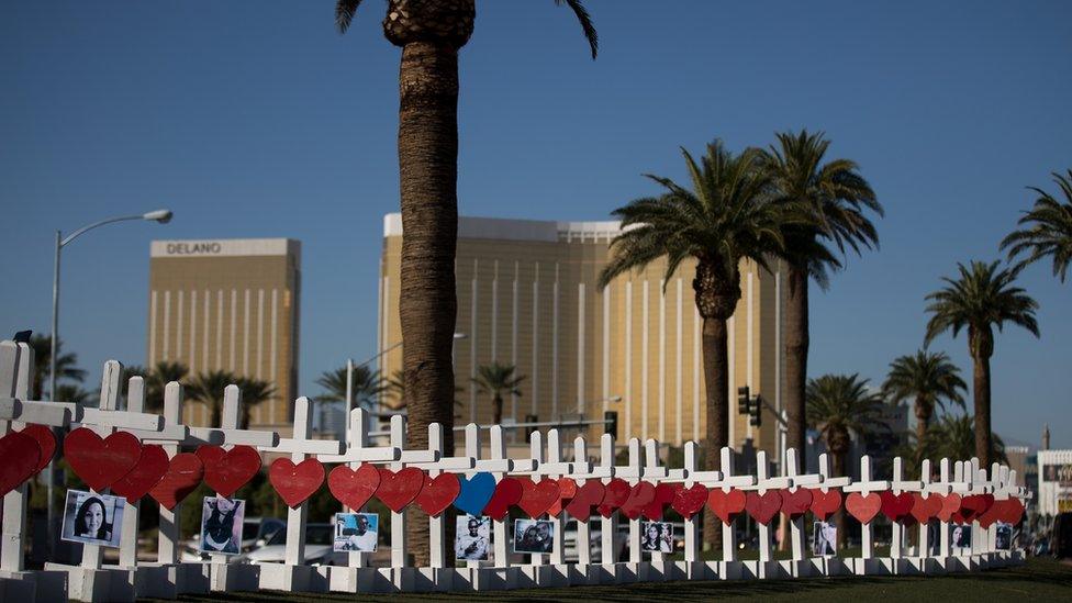 With the Mandalay Bay Resort and Casino in the background (at right), 58 white crosses for the victims of Sunday night's mass shooting stand on the south end of the Las Vegas Strip, October 5, 2017 in Las Vegas, Nevada.