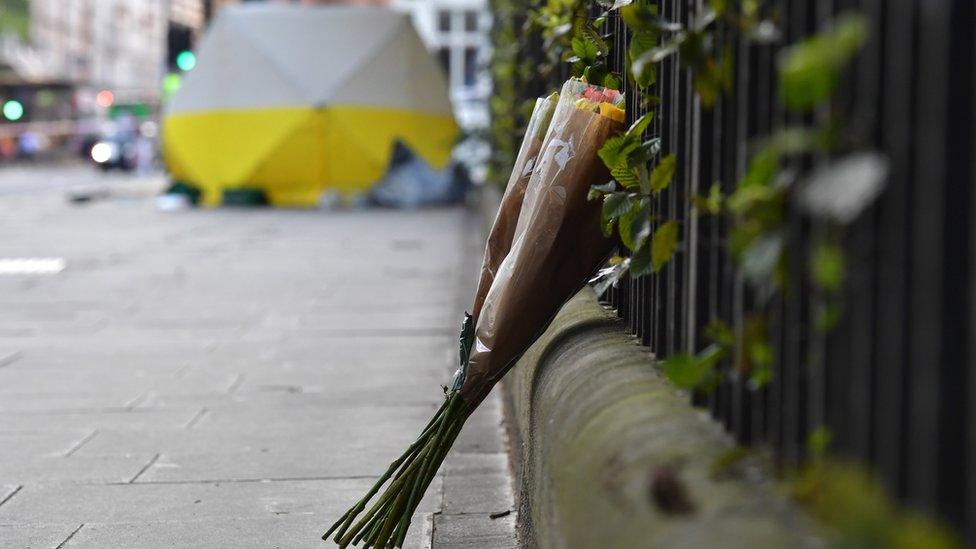 Flowers are left near the scene of a knife attack on 4 August 2016 in London, England.
