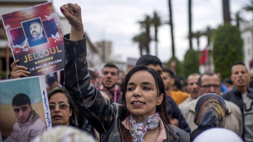 Moroccan protesters shout slogans during a protest