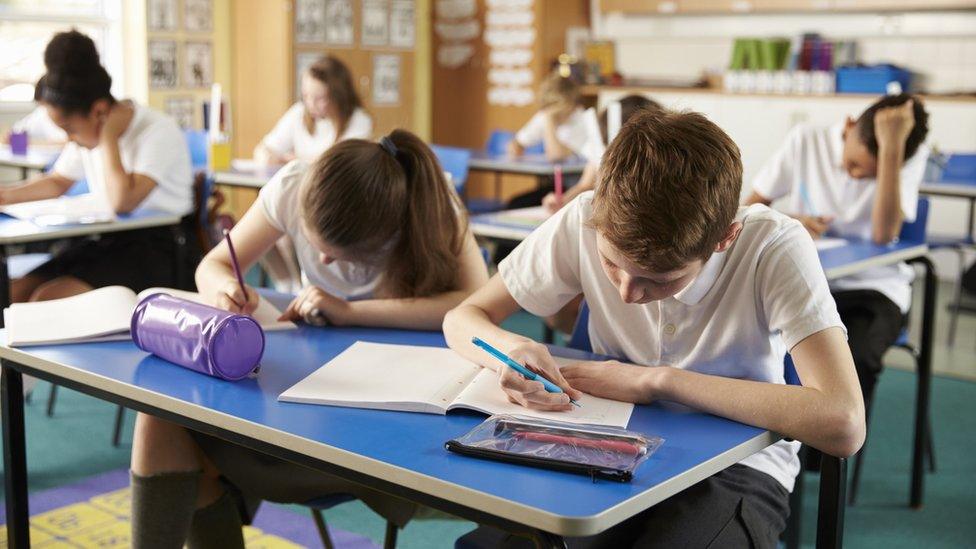 A school classroom where children are studying