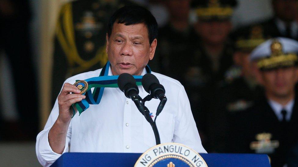 Philippine President Rodrigo Duterte shows his medal at the armed forces Commander-in-Chief change-of-command ceremony at Camp Aguinaldo in Quezon city, northeast of Manila, Philippines, 7 December 2016.