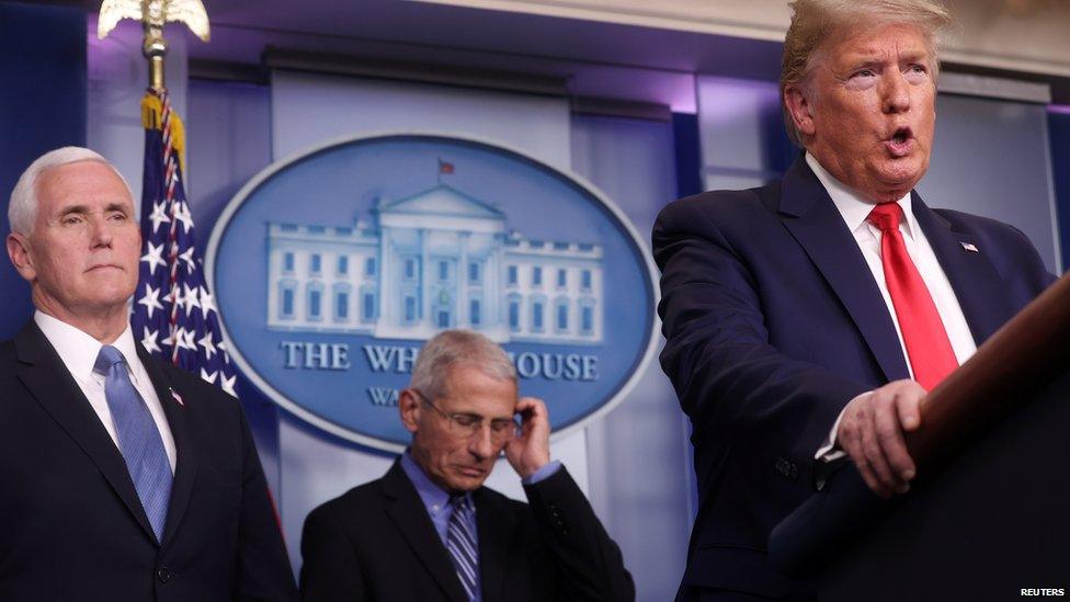 Dr Fauci looks down while President Trump talks about coronavirus