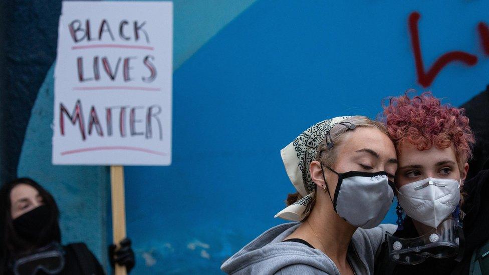 Demonstrators hold a rally and teach-in outside of the Seattle Police Departments East Precinct, which has been boarded up and protected by fencing, on June 8, 2020 in Seattle, Washington.