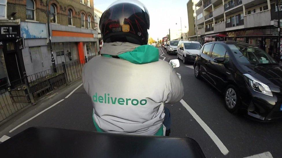 Deliveroo scooter rider from beind