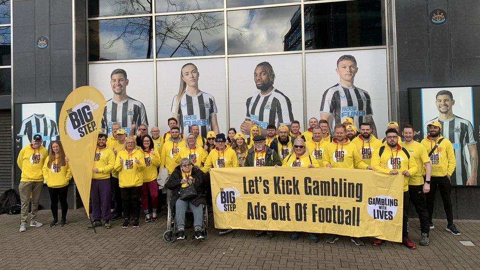 Campaigners gathered outside St James' Park holding a banner reading "Let's kick gambling out of football"