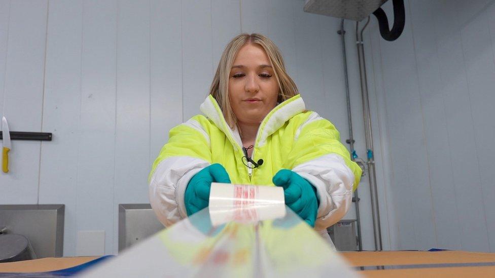 Natasha Varley, food inspector tapes boxes of chicken up