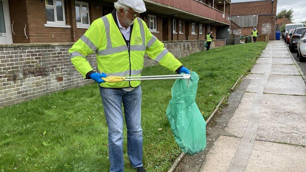 Resident picking up litter