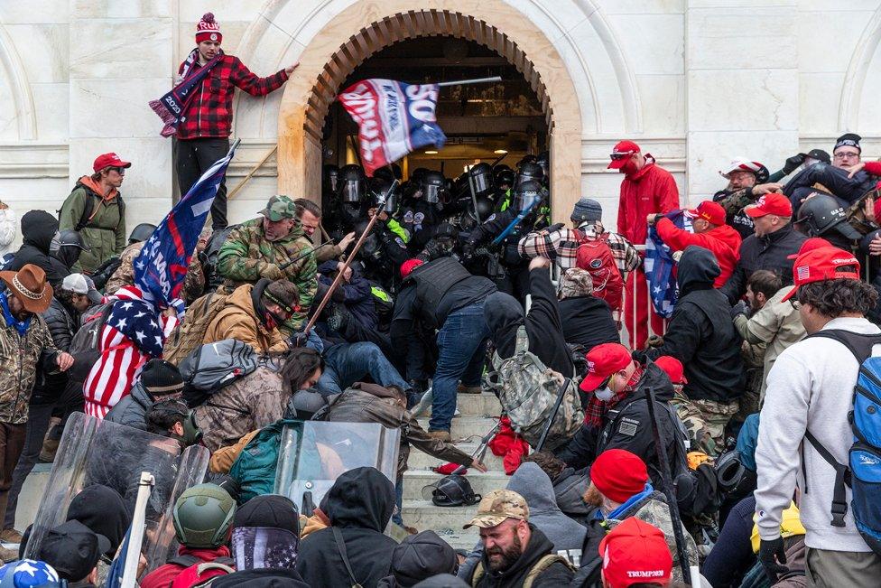 Rioters clash with police while trying to enter the US Capitol building, in Washington, DC. 6 January 2021