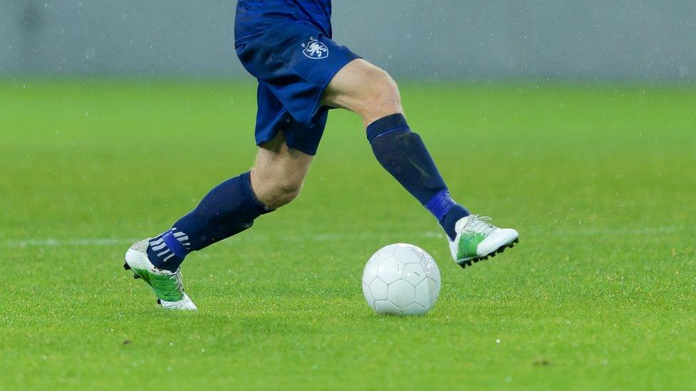 Footballer playing with football