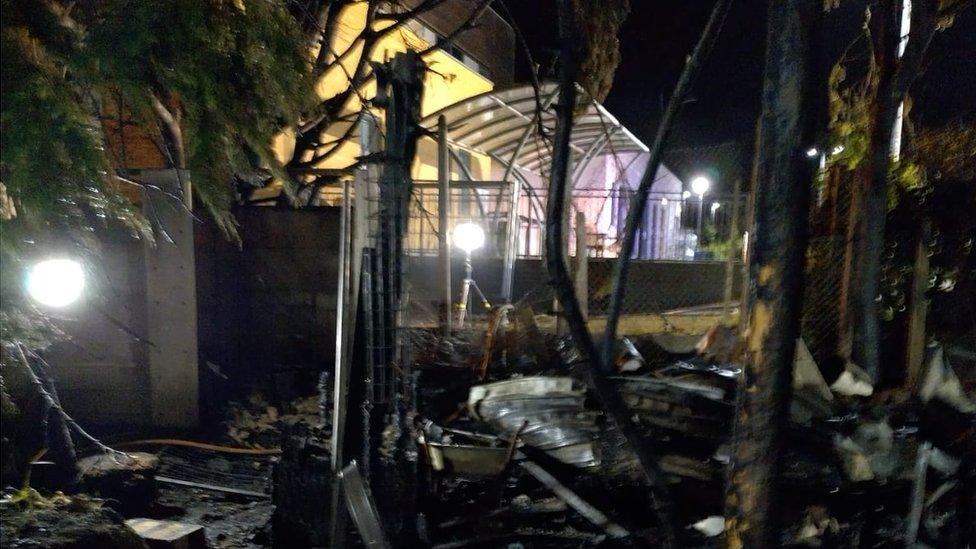 Burnt out remains of sheds and trees after grassland fire near Fryatt hospital