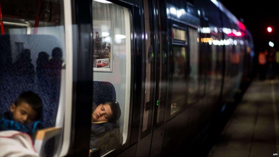 Child migrants asleep on a train to Germany