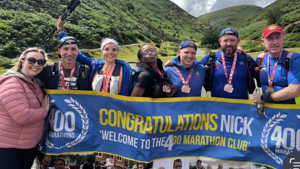 Nick Cockburn with members of the 100 Marathon Club