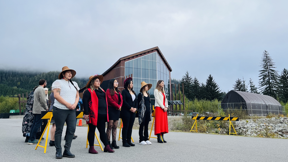 Photo of members of the Nisga'a Nation awaiting the arrival of the totem pole in front of the Nisga'a Museum