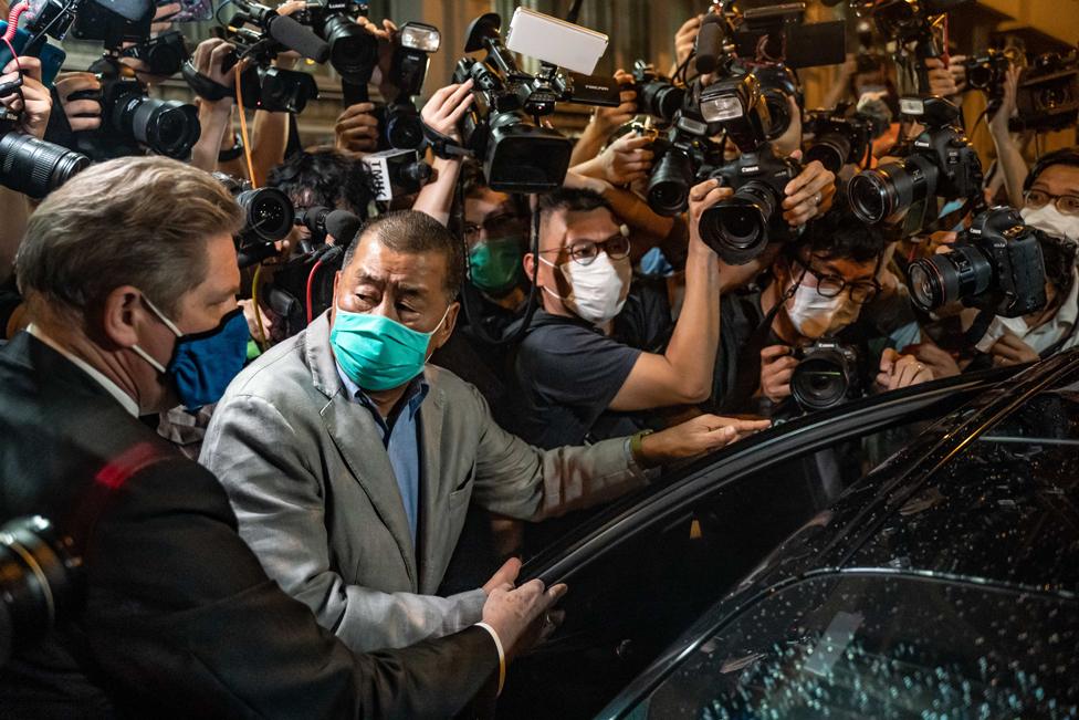 Hong Kong pro-democracy media tycoon Jimmy Lai surrounded by photographers