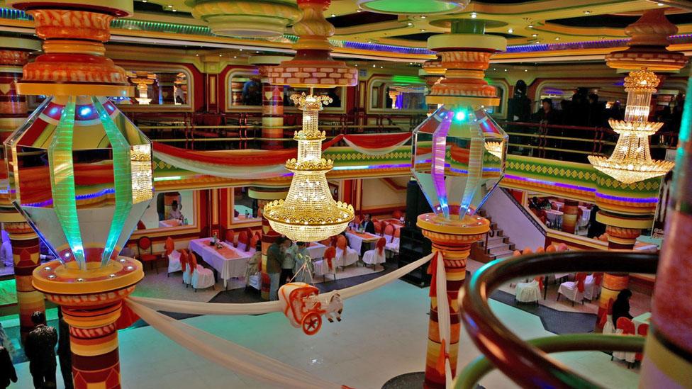 Tables are set up for a wedding in a cholet in El Alto