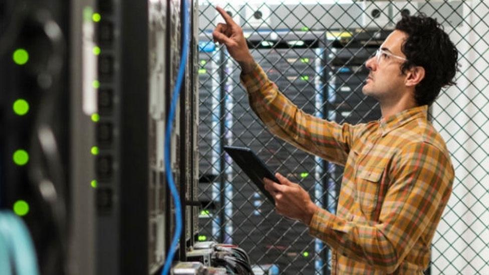 Man examining a server rack