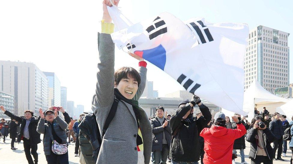 People react about the decision of the Constitutional Court over the impeachment of South Korean President Park Geun-hye in Seoul, South Korea 10 March 2017