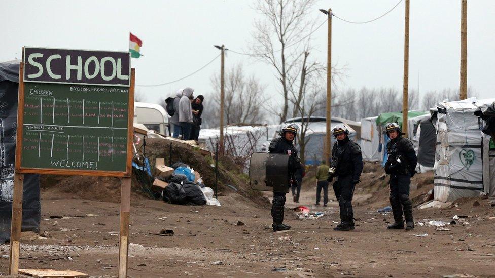 School sign at Calais migrant camp