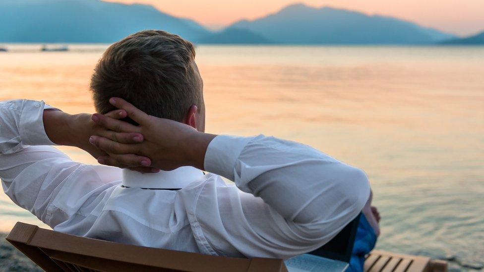 Man in shirt looking at lake