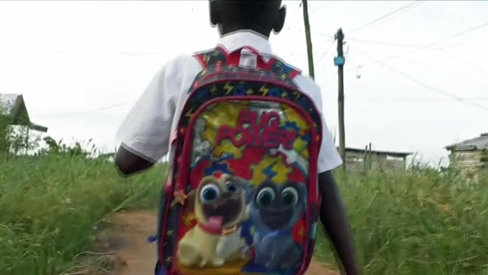 A boy going to an illegal school in Douala, Cameroon