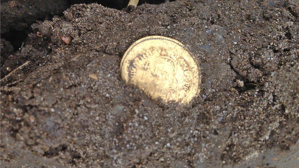 The coin in the ground when it was first revealed