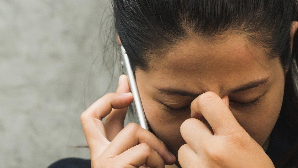 stock photo of an upset woman making a phone call