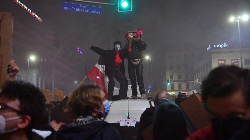 Protesters block a street in the city centre during a protest against the tightening of the abortion law in Warsaw, Poland