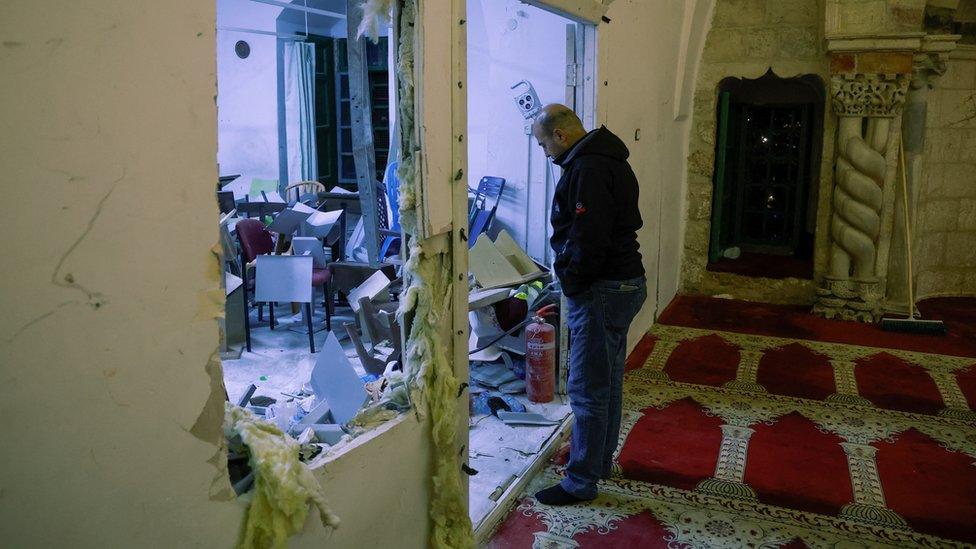 A man looks at damage inside the al-Aqsa mosque, following clashes between Israeli police and Palestinian worshippers, in occupied East Jerusalem (5 April 2023)