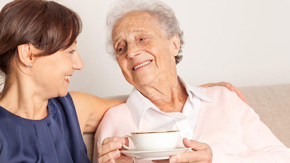 Stock image of an elderly woman and her caregiver