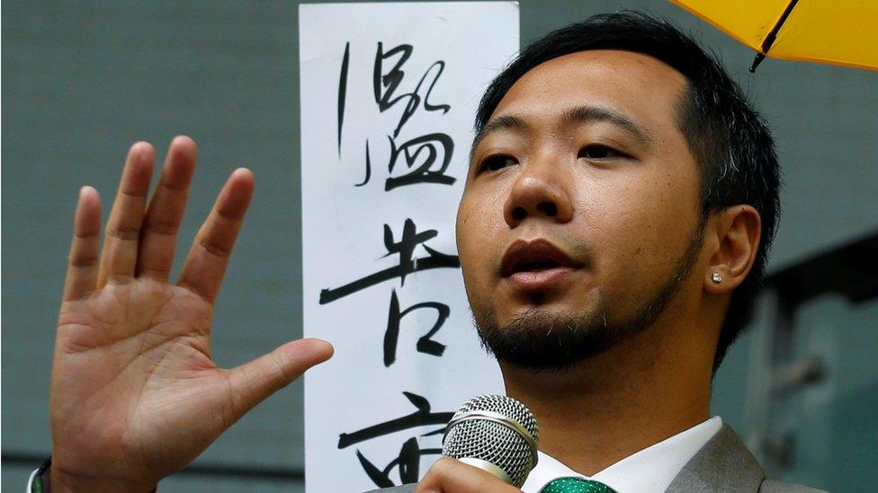 Ken Tsang addressing a crowd with a microphone outside court on 30 May 2016