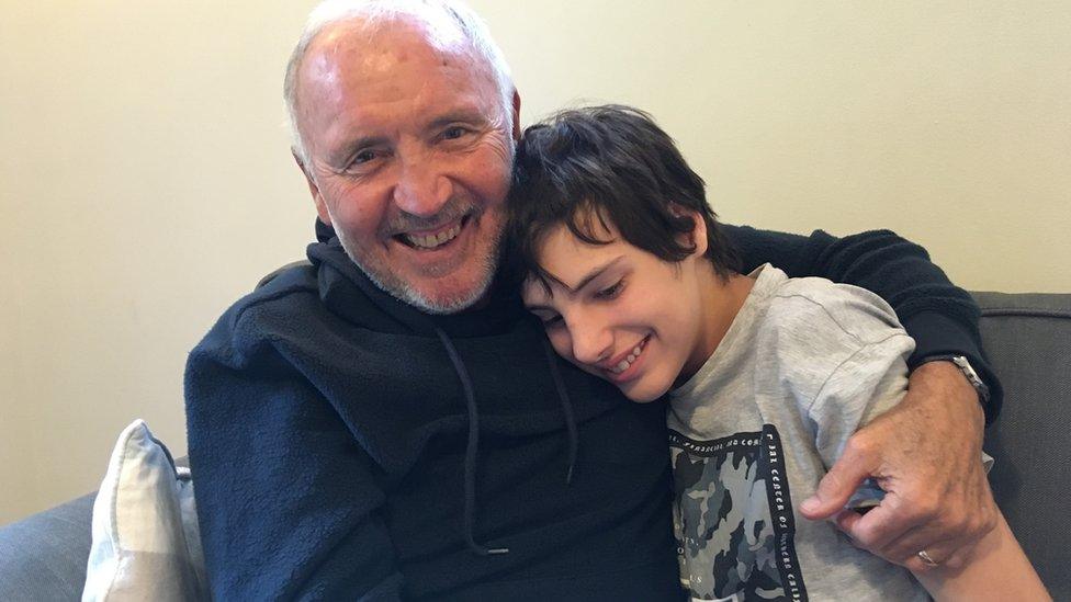 Barry Bridges smiling with a teenage boy who he looked after