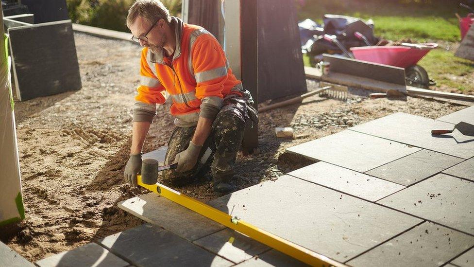 A man laying a patio