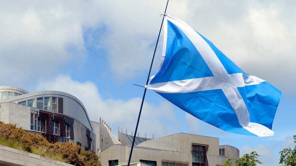 Saltire flag flying outside Scottish Parliament