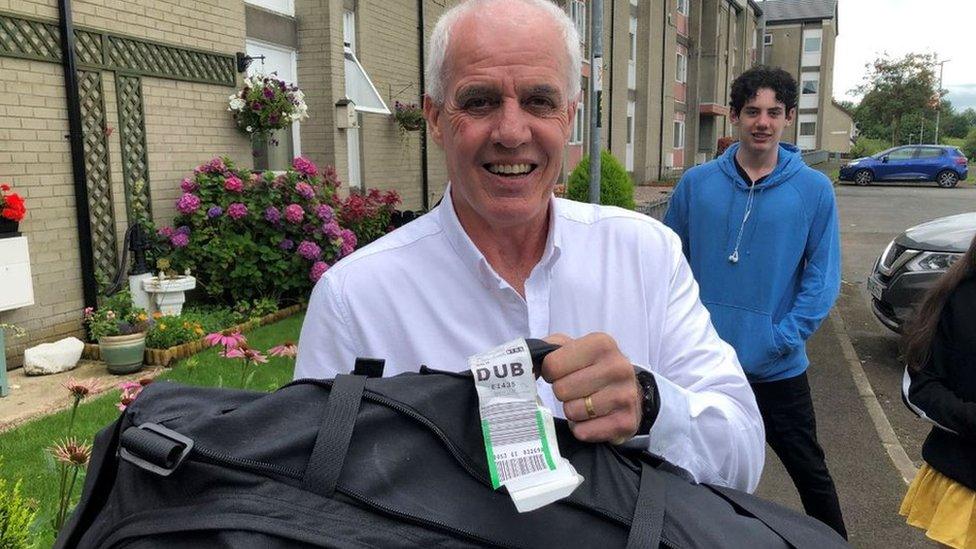 Bob Gilmour and his son Declan with their returned luggage