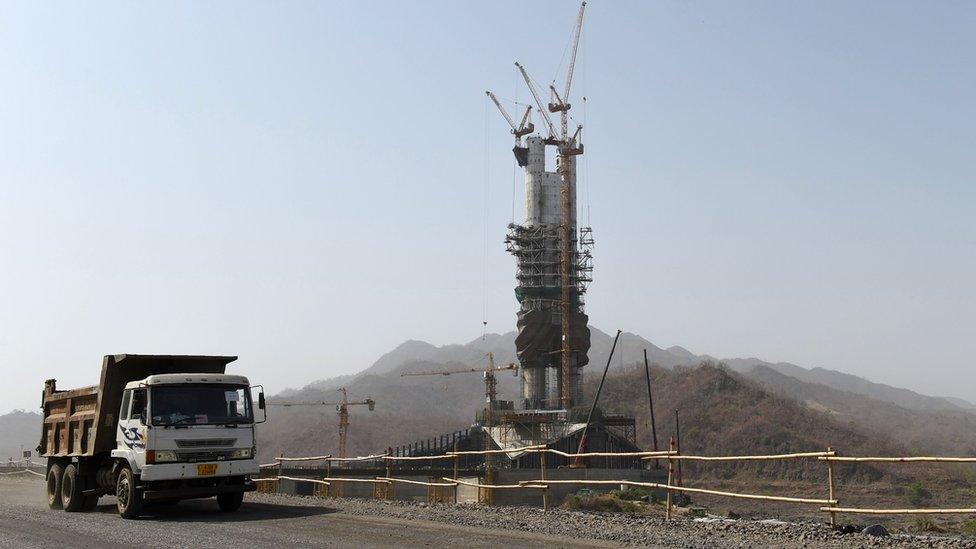 The statue alongside a construction truck in a rural part of Gujarat state