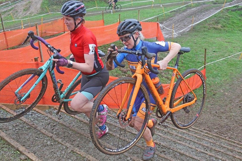 Laura Prime, in red, and Elvita Branch, running up the steps at Trinity Park in the Regional Championships at Trinity Park