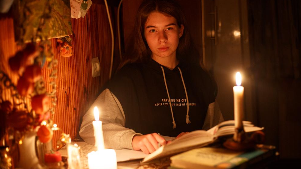 girl studies by candlelight in Ukraine