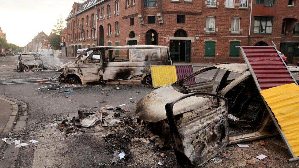 View of a street with cars, burnt during night clashes in Roubaix, northern France, 30 June 2023.