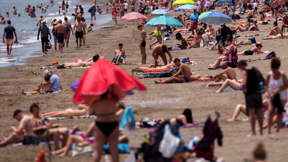 People enjoy a sunny day at the beach in Malaga, southern Spain, 02 June 2020. The province of Malaga has reached phase 2 of the de-escalation process scheduled by the Spanish central Government's plan to stop the spreading of coronavirus.