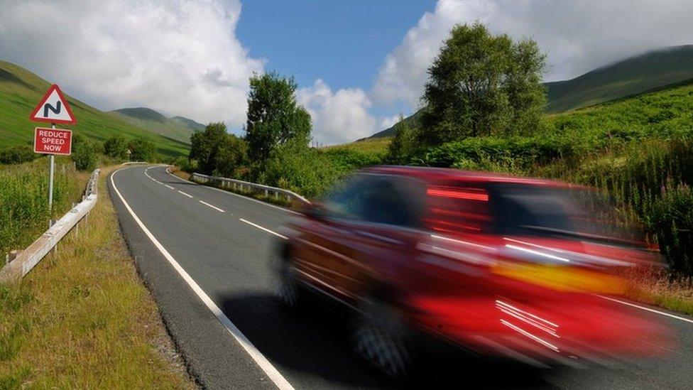 A car speeding on a road