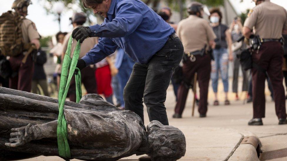 A statue of Christopher Columbus, which was toppled to the ground by protesters, in St Paul, Minnesota