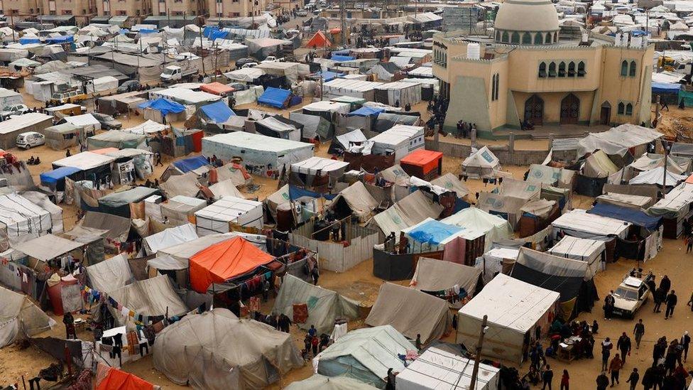 Displaced Palestinians, who fled their houses due to Israeli strikes, shelter at a tent camp, amid the ongoing conflict between Israel and Hamas, in Rafah in the southern Gaza Strip