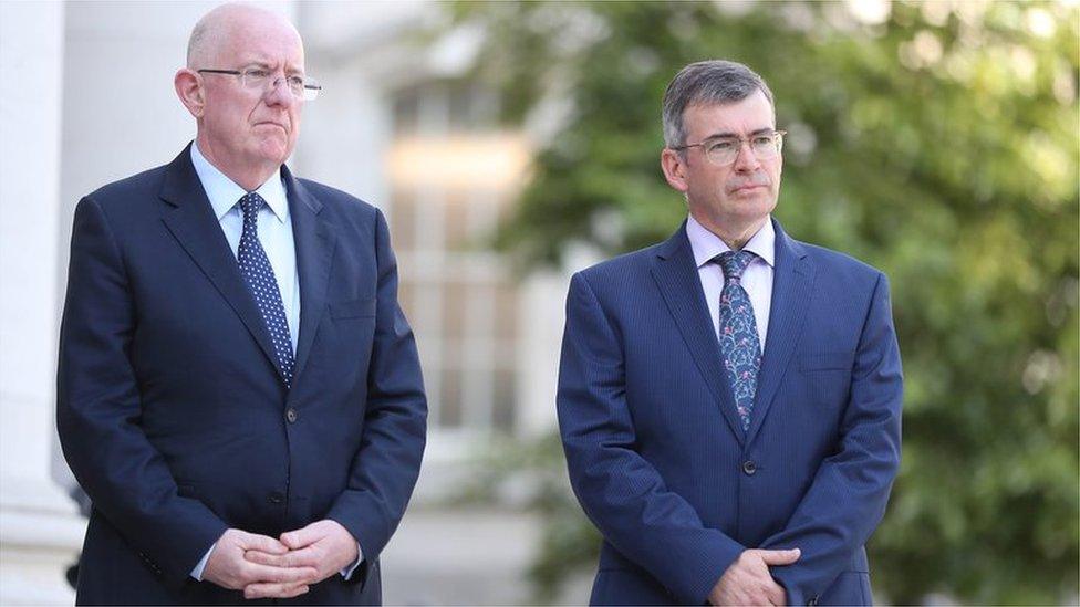 Charlie Flanagan (left) has defended the incoming garda commissioner Drew Harris (right)