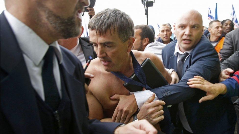 Xavier Broseta, Executive Vice President for Human Resources and Labour Relations at Air France, is evacuated by security after employees interrupted a meeting at the Air France headquarters building in Roissy